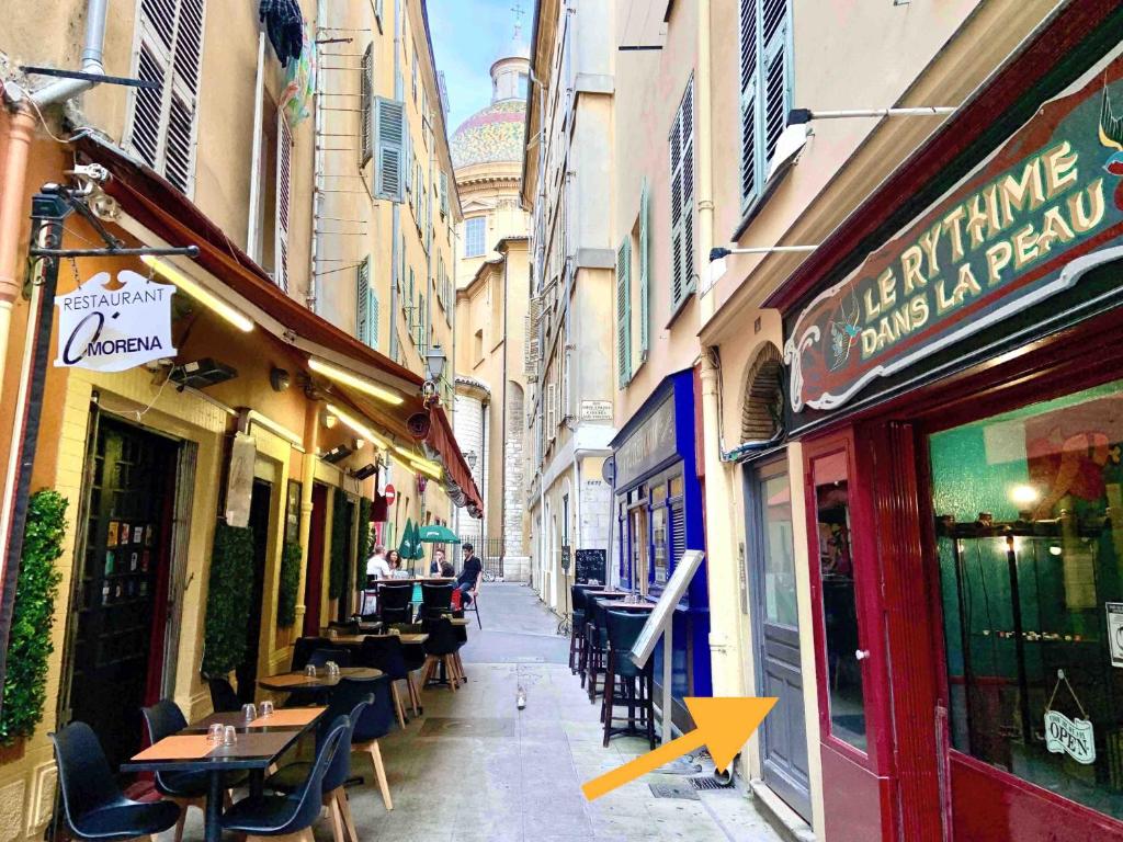 a city street with tables and chairs and buildings at Papa Riviera - Nice Old Town - 2 bedrooms in Nice