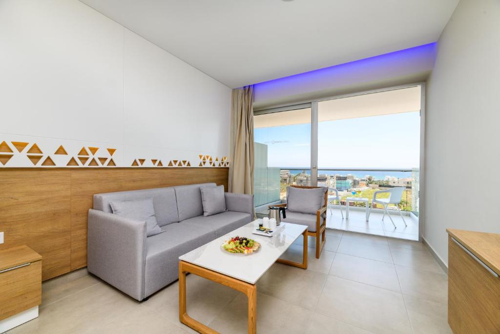 a living room with a couch and a table at Seasons Hotel (Adults Only) in Ayia Napa