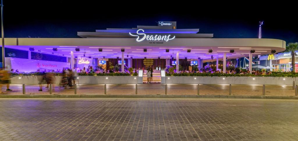 a building with purple lights in front of a street at Seasons Hotel (Adults Only) in Ayia Napa