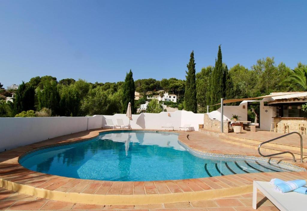 a large swimming pool in a yard with a patio at Finca La Ferma in Pedramala