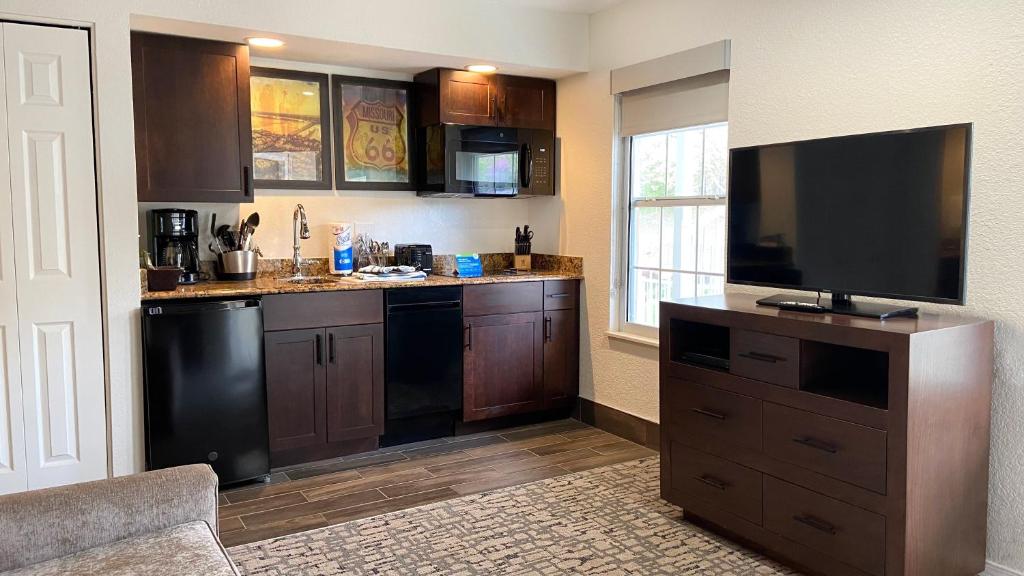 a kitchen with a flat screen tv on a counter at Club Wyndham Branson at The Falls in Branson