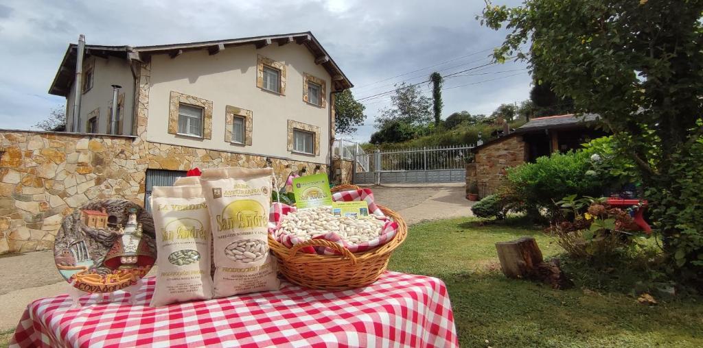 una mesa de picnic con una cesta de comida. en Apartamentos Casa Alvarina - Luarca, en Cortina