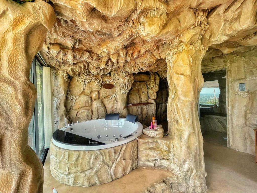 a bath tub in a rock wall in a room at Podere Raffanna Ecologic House in Massa e Cozzile