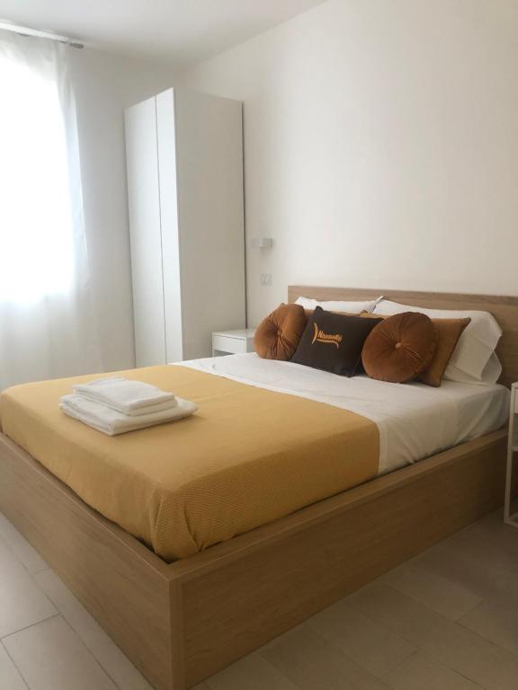 a bedroom with a large bed with brown pillows at NANNARE' APPARTAMENT in Reggio Emilia