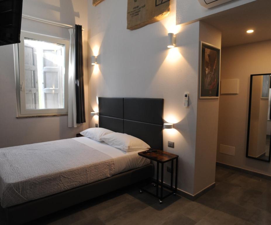 a bedroom with a bed and a window and lights at TLcafè Hospitality (presso Torrefazione Lady Cafè srl) in San Secondo Parmense