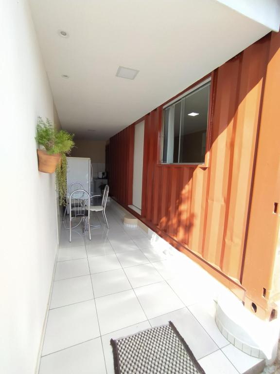 a balcony with a table and chairs on it at Container LB com garagem para carros de até 4,5M in Boa Vista