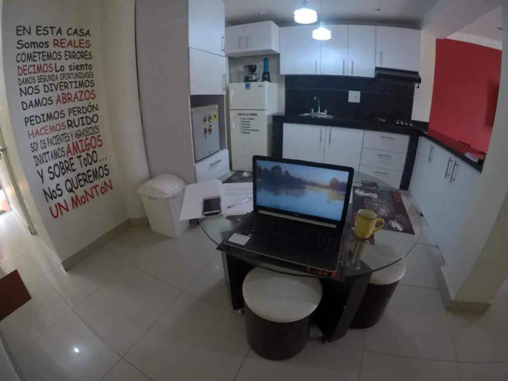 a laptop computer sitting on a table in a kitchen at La casita de max y tim apt 201 in Cartagena de Indias