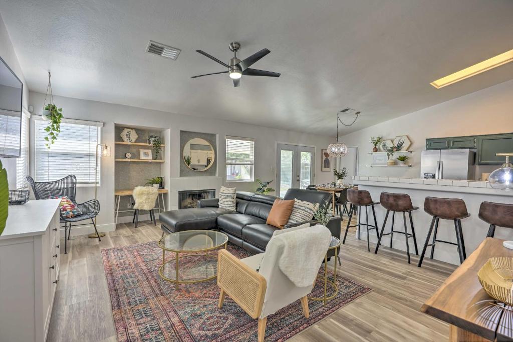 a living room with a couch and a table at Stylish Bakersfield Getaway with Pool Table! in Bakersfield