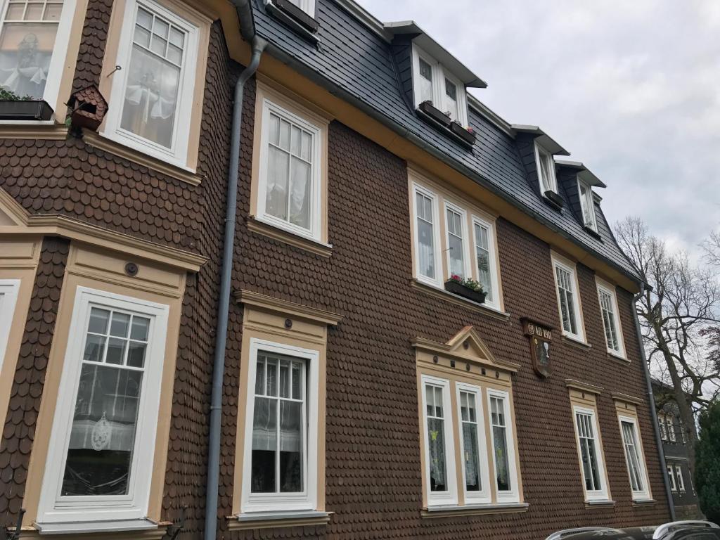 a brown brick house with white windows at Ferienwohnung Eichhörnchen in Suhl