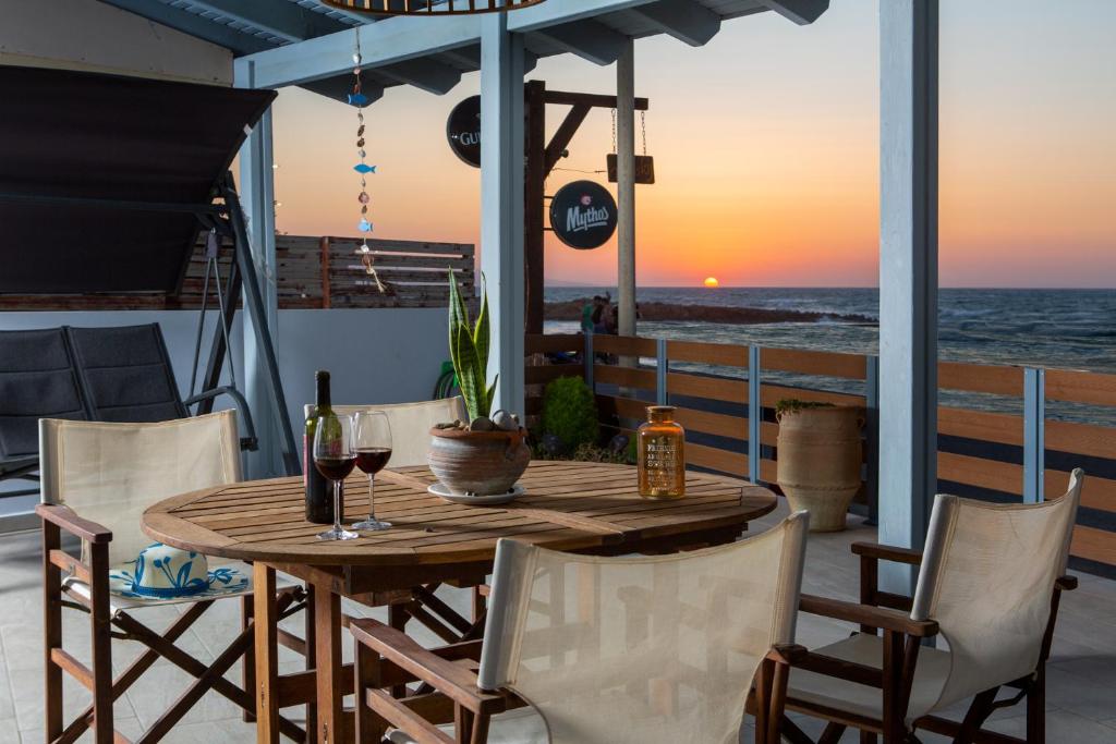 a table and chairs on a patio with a view of the ocean at Kyma Seafront Suite by Estia in Kokkini Khanion