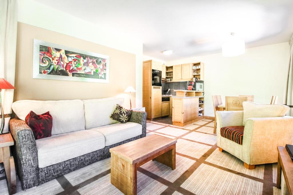 a living room with a couch and a table at Spacious Family 2-bed, 2-bath with parking, private piste in Flaine