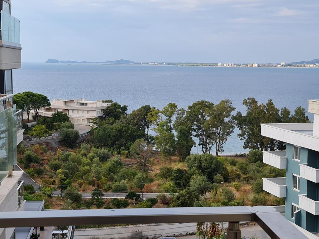 a view of the water from the balcony of a building at Holiday One Bedroom Sea View Apartment Vlore in Vlorë