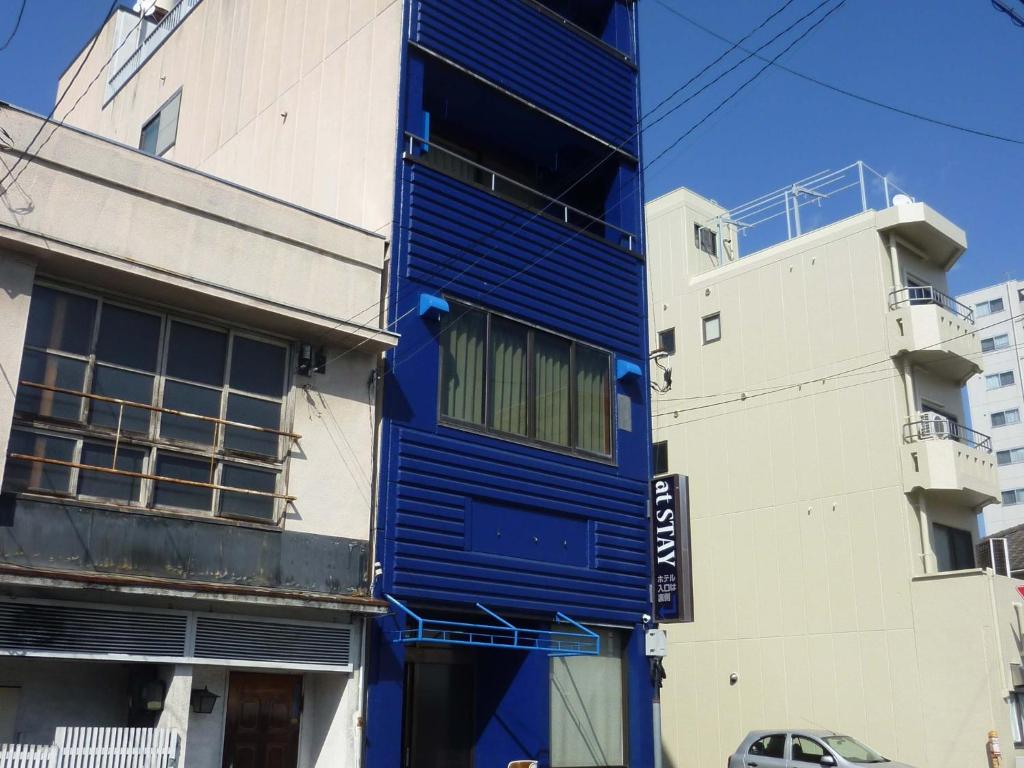 a blue building on the side of a building at At stay / Vacation STAY 63761 in Okayama