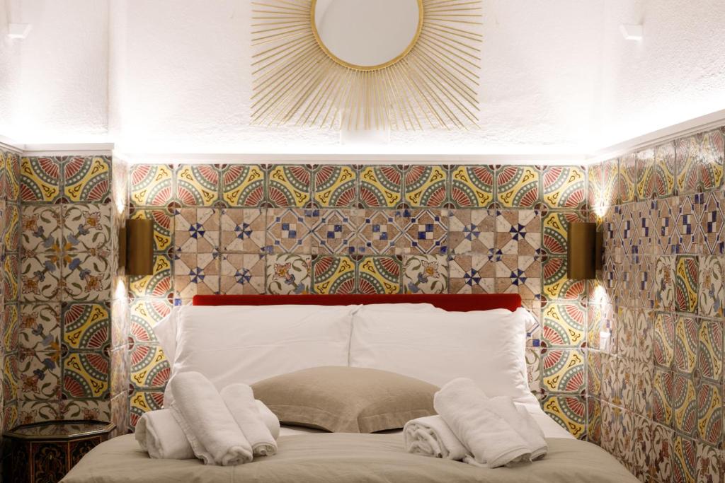a bedroom with a bed with two towels on it at Qasar Luxury Suite - in Capri's Piazzetta in Capri