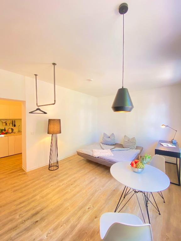 a living room with a bed and a table at Studiowohnung 1 in Buxtehude in Buxtehude