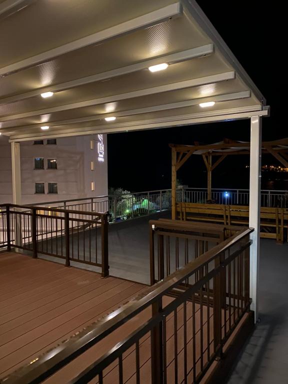 a balcony of a building at night at Overwave Apartment in Kavála