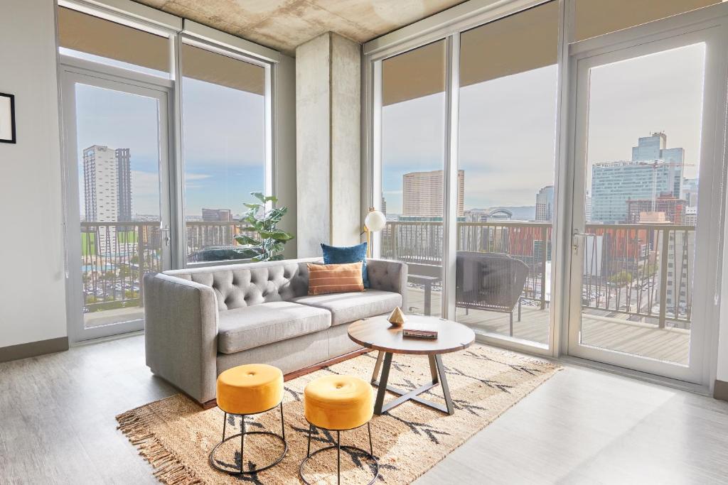 a living room with a couch and large windows at Sonder at McKinley in Phoenix