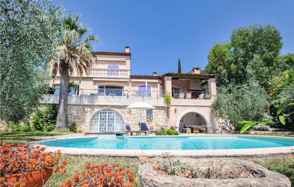 a house with a swimming pool in front of it at Amazing Home In Le Tignet in Le Tignet