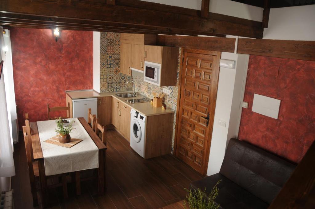 a kitchen with a table and a stove top oven at EL VASALLO 2 in Tragacete