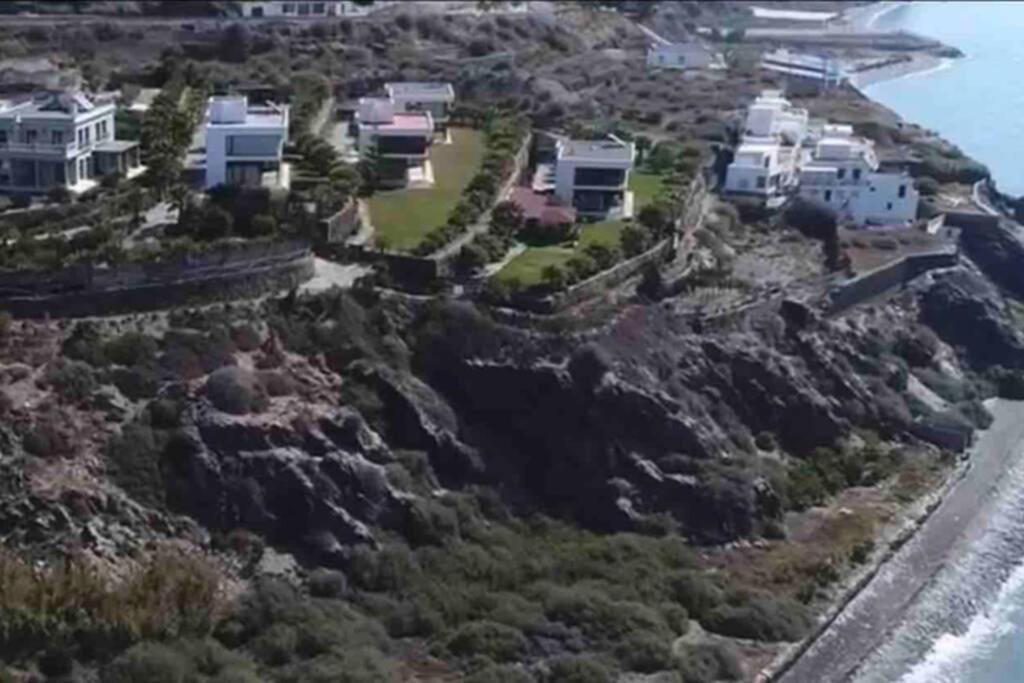 an aerial view of houses on a cliff next to the ocean at Alcazaba Hills in Adra