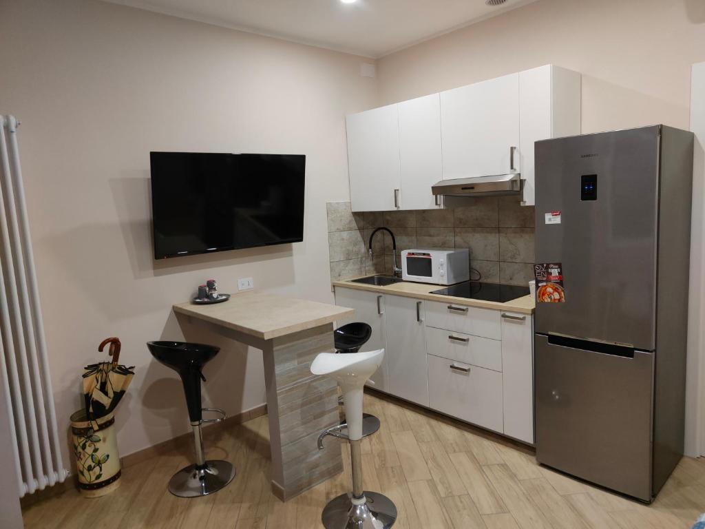 a kitchen with a stainless steel refrigerator and a counter at Montanara2 in Parma