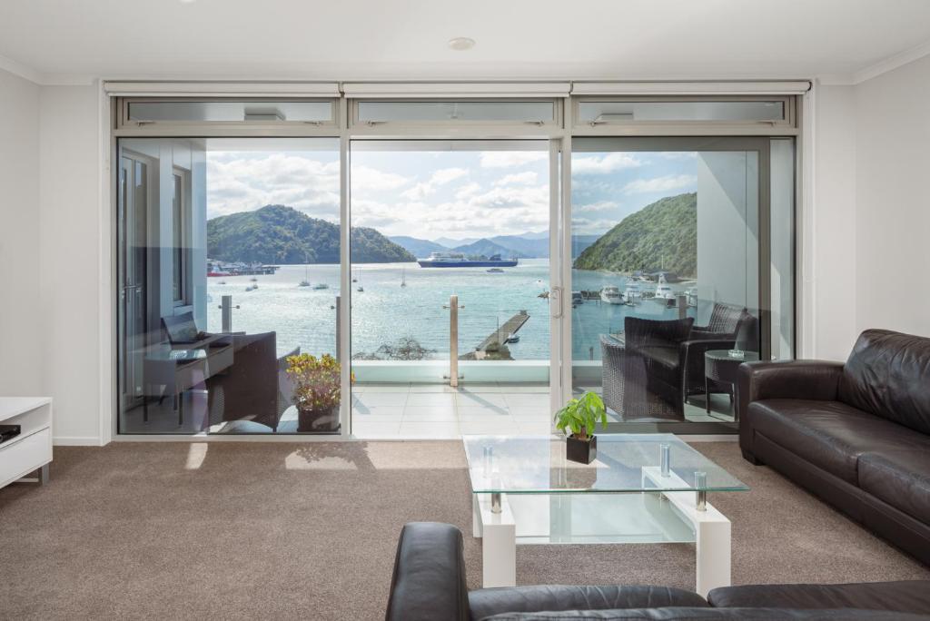 a living room with a view of the water at Oxleys Penthouse 506 in Picton