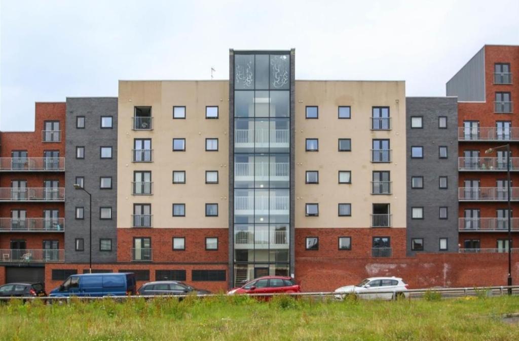 a group of buildings with cars parked in front of them at Manchester City Quantum in Manchester