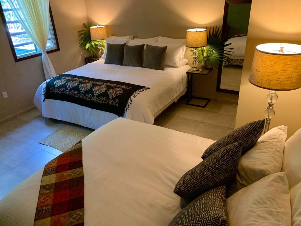 a bedroom with a bed and a lamp at Casa Boutique Hokhmah in Puerto Morelos