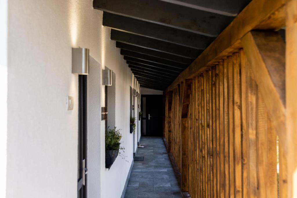 a hallway of a building with wooden walls at Corvin Guesthouse in Hunedoara