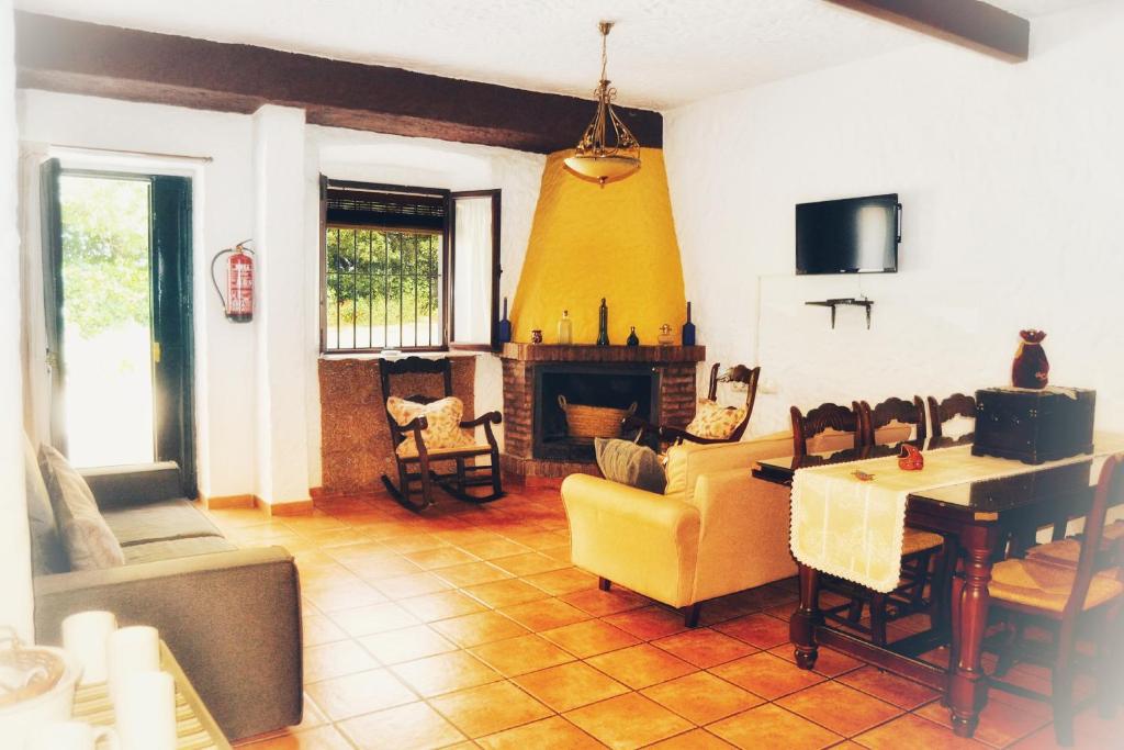 a living room with a yellow couch and a table at El Antiguo Molino in El Bosque