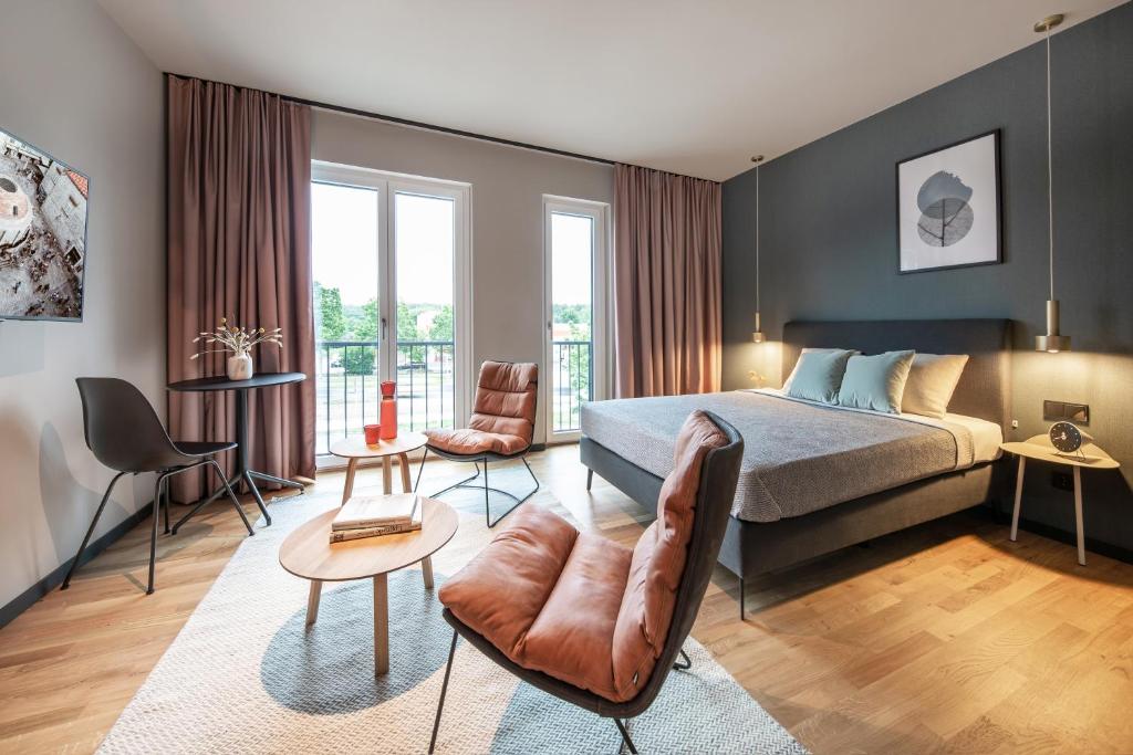 a bedroom with a bed and a living room at ipartment Braunschweig in Braunschweig