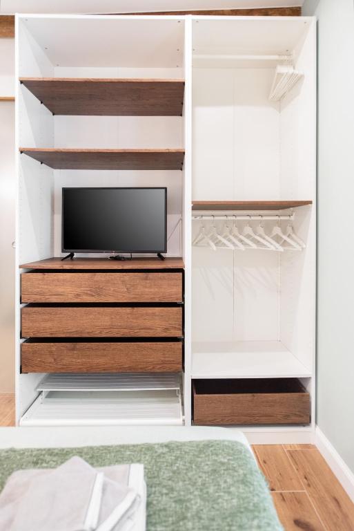 A television and/or entertainment centre at Elegant Suite in Milan Center