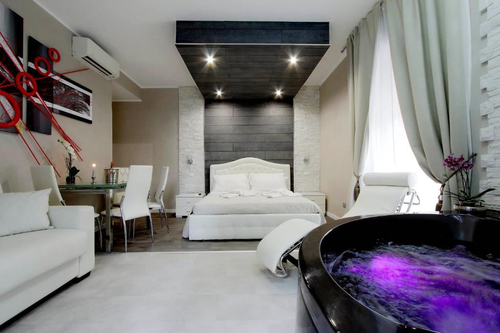 a bedroom with a bed and a tub at Suite Paradise Rome in Rome