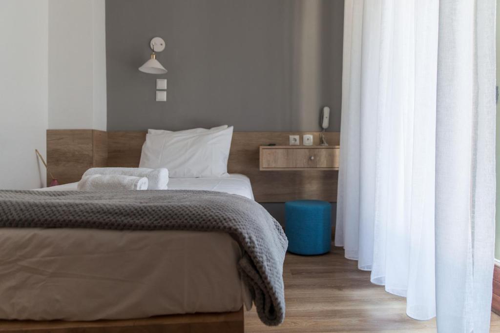 Postel nebo postele na pokoji v ubytování Olympos Hotel