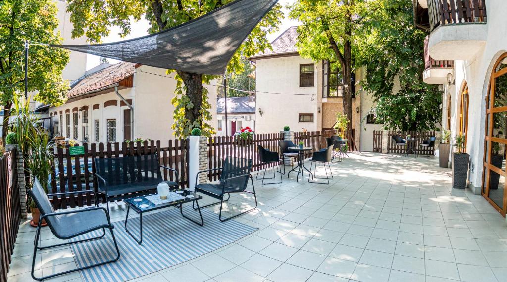 a group of chairs and tables on a patio at Richter Pansion in Budapest