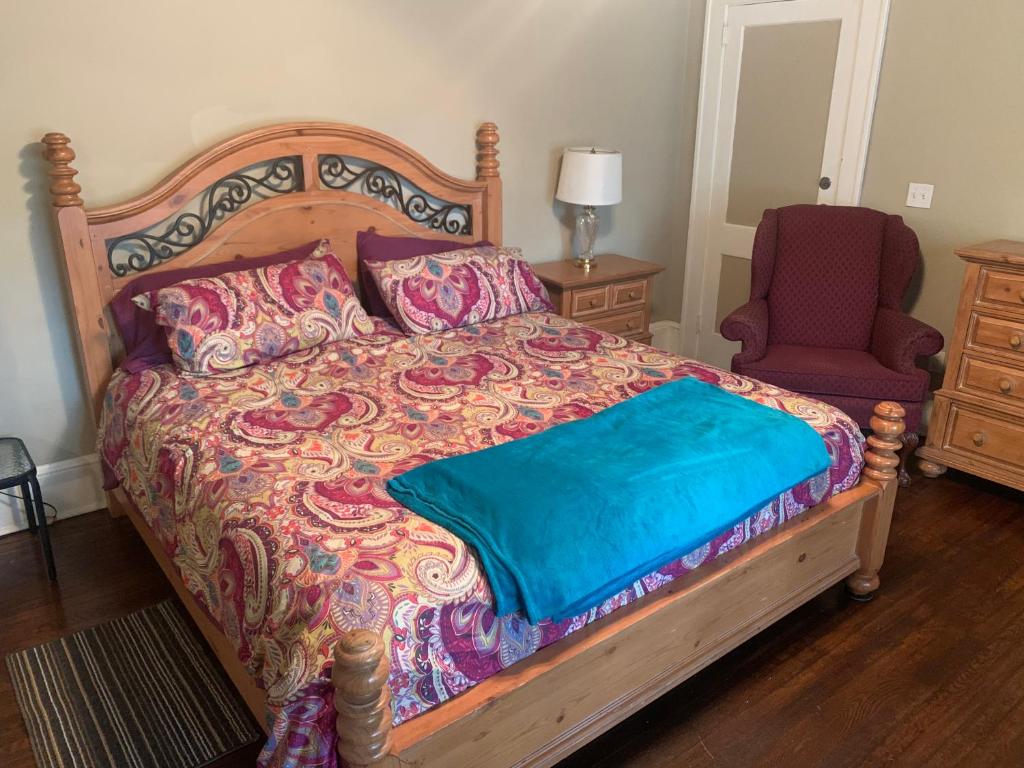 a bedroom with a large bed and a red chair at Magnificent Place-Moreland in Atlanta