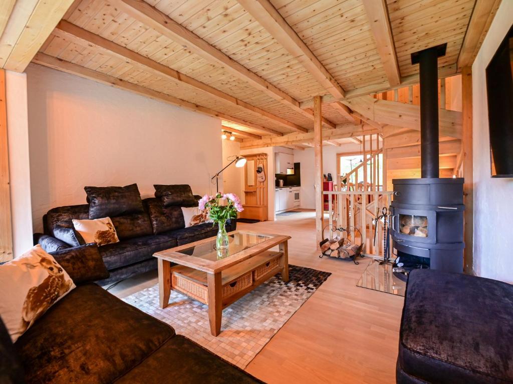 a living room with a couch and a wood stove at Chalet La Paisible by Interhome in Ovronnaz