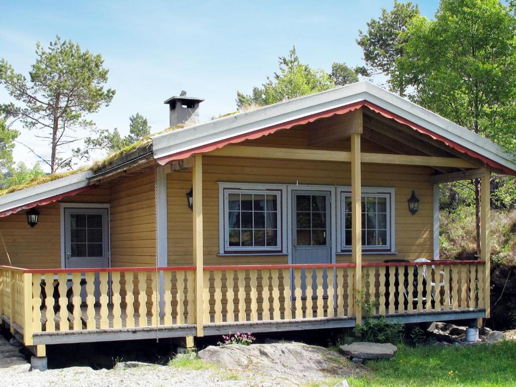 a small wooden house with a tin roof at Holiday Home Solbakken - FJS547 by Interhome in Gjølanger