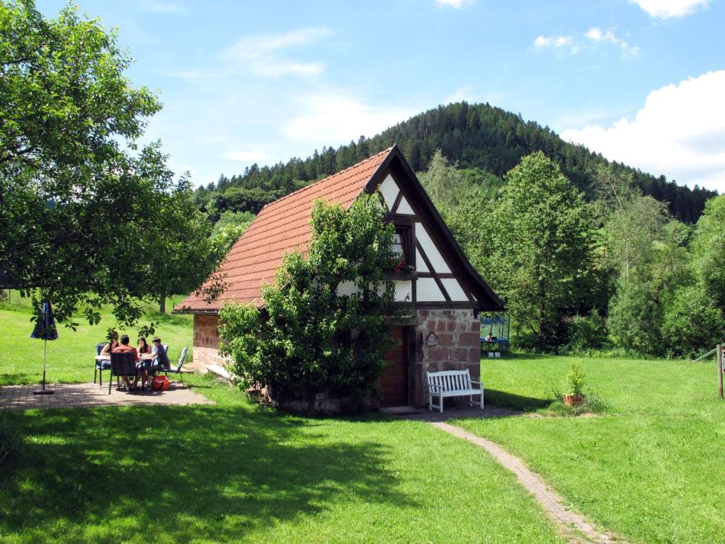 a group of people sitting in front of a building at Holiday Home Backhäusle by Interhome in Unterehlenbogen