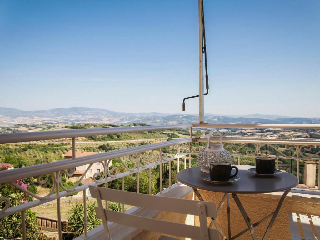 a table and chairs on a balcony with a view at Apartment Agave by Interhome in Civitella Marittima