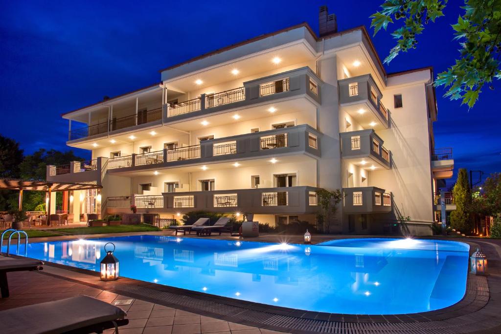 a villa with a swimming pool at night at Electra Hotel in Stavros