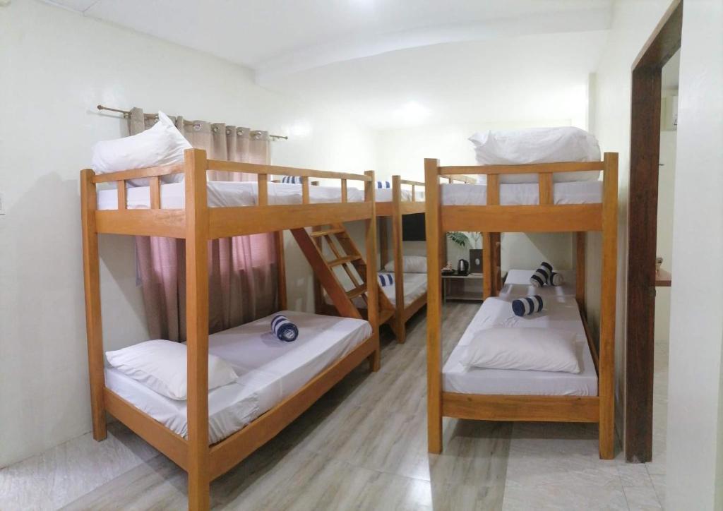 a group of bunk beds in a room at Acapulco Resort in Toledo City