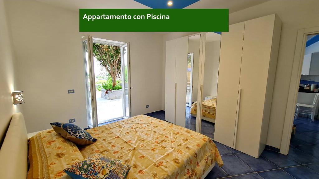 a bedroom with two beds and a mirror at Il Sogno in Ischia