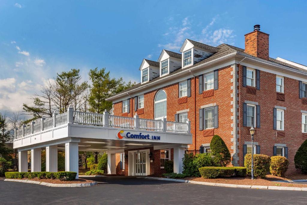 a large red brick building with a sign on it at Comfort Inn Rockland - Boston in Rockland