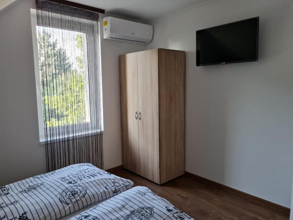 Posteľ alebo postele v izbe v ubytovaní Holdudvar Apartman