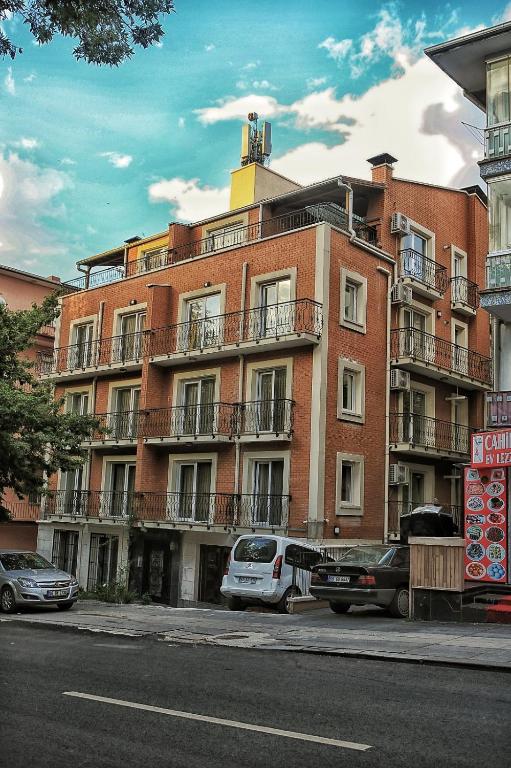 a large brick building with cars parked in front of it at CONCEPT HoUSE in Ankara