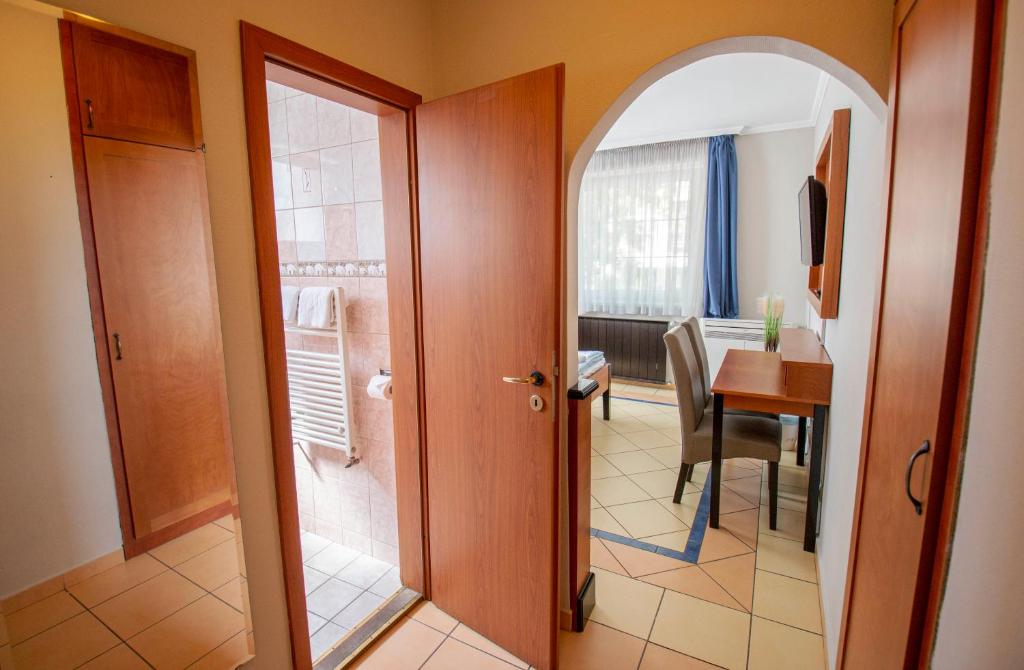 a door to a room with a table and a dining room at Richter Pansion in Budapest