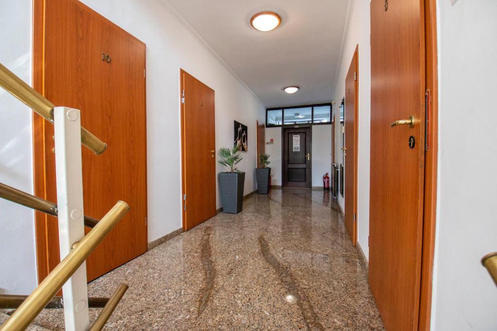 an empty hallway with wooden doors and a staircase at Richter Pansion in Budapest
