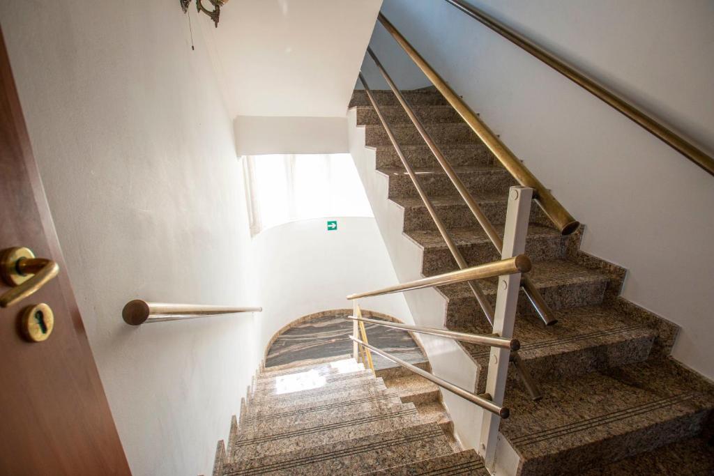 a staircase in a house with a wooden door at Richter Pansion in Budapest