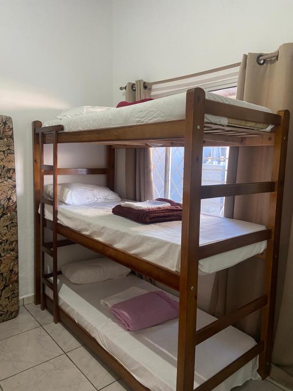 a couple of bunk beds in a room at Casa da Si Hostel in Ubatuba